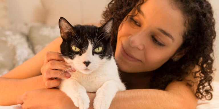 woman looking lovingly at cat