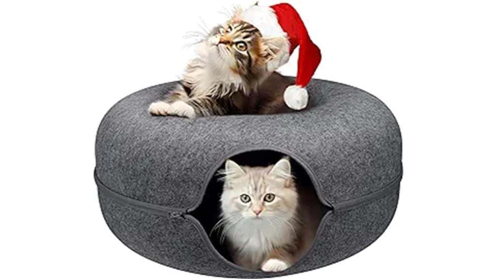 Two cats sitting in a cat bed with a santa hat.